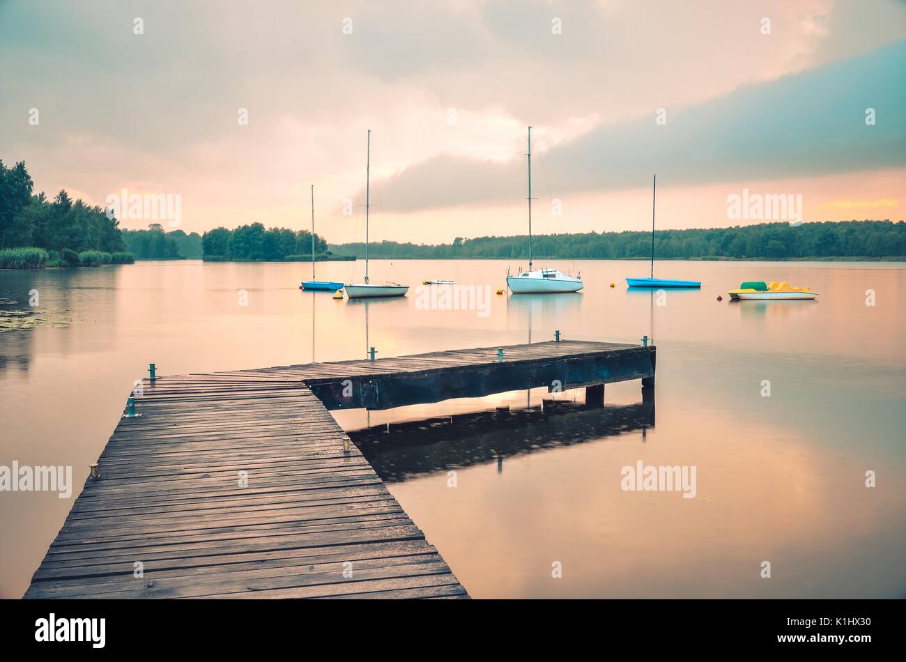 Boats on the water. Wooden pier and boat on a beautiful lake Stock ...