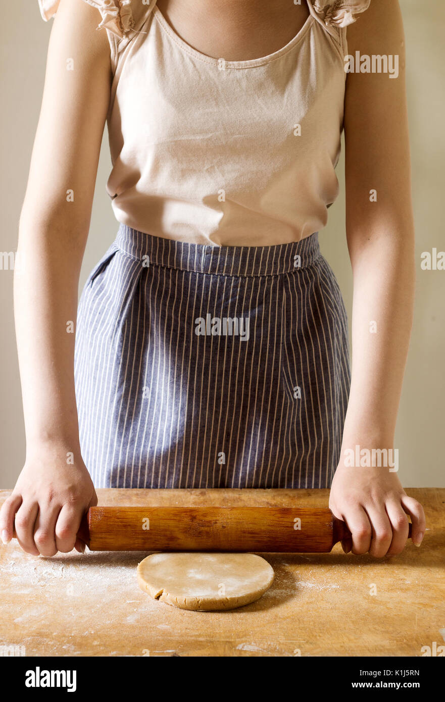 Woman rolling dough for gingerbread, rustic style, selective focus Stock Photo