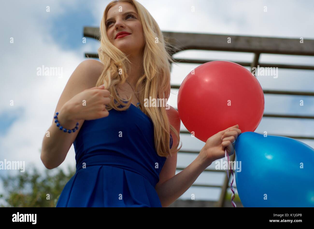 Woman blonde in blue dress hi-res stock photography and images - Alamy