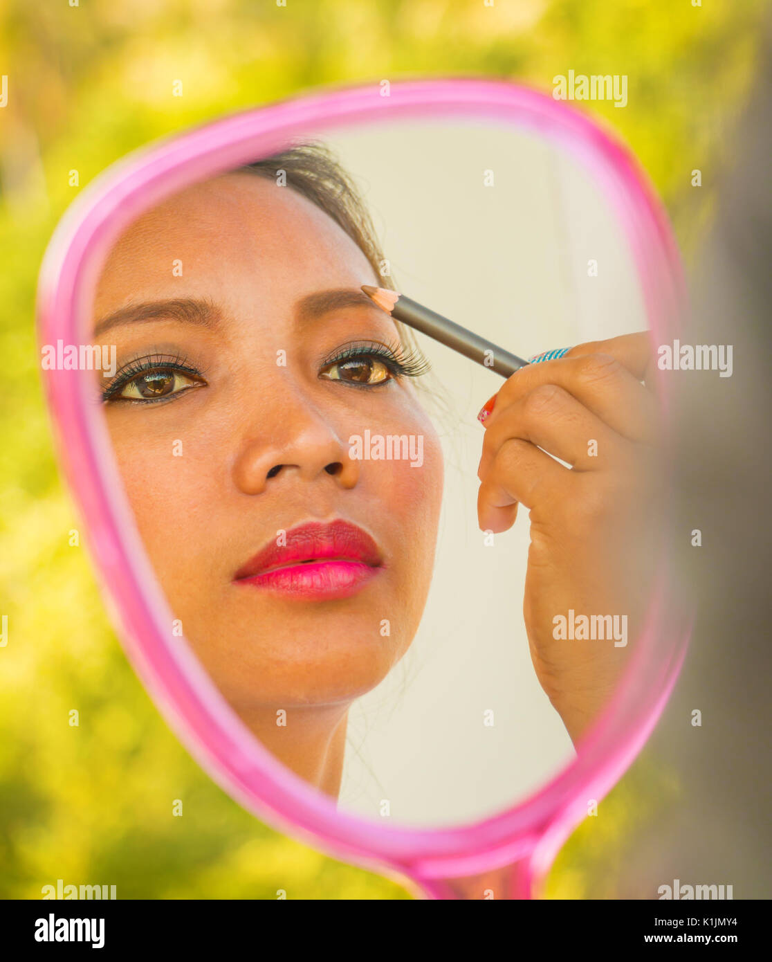 Applying Eyebrows Makeup In Mirror Showing Cosmetics Stock Photo Alamy