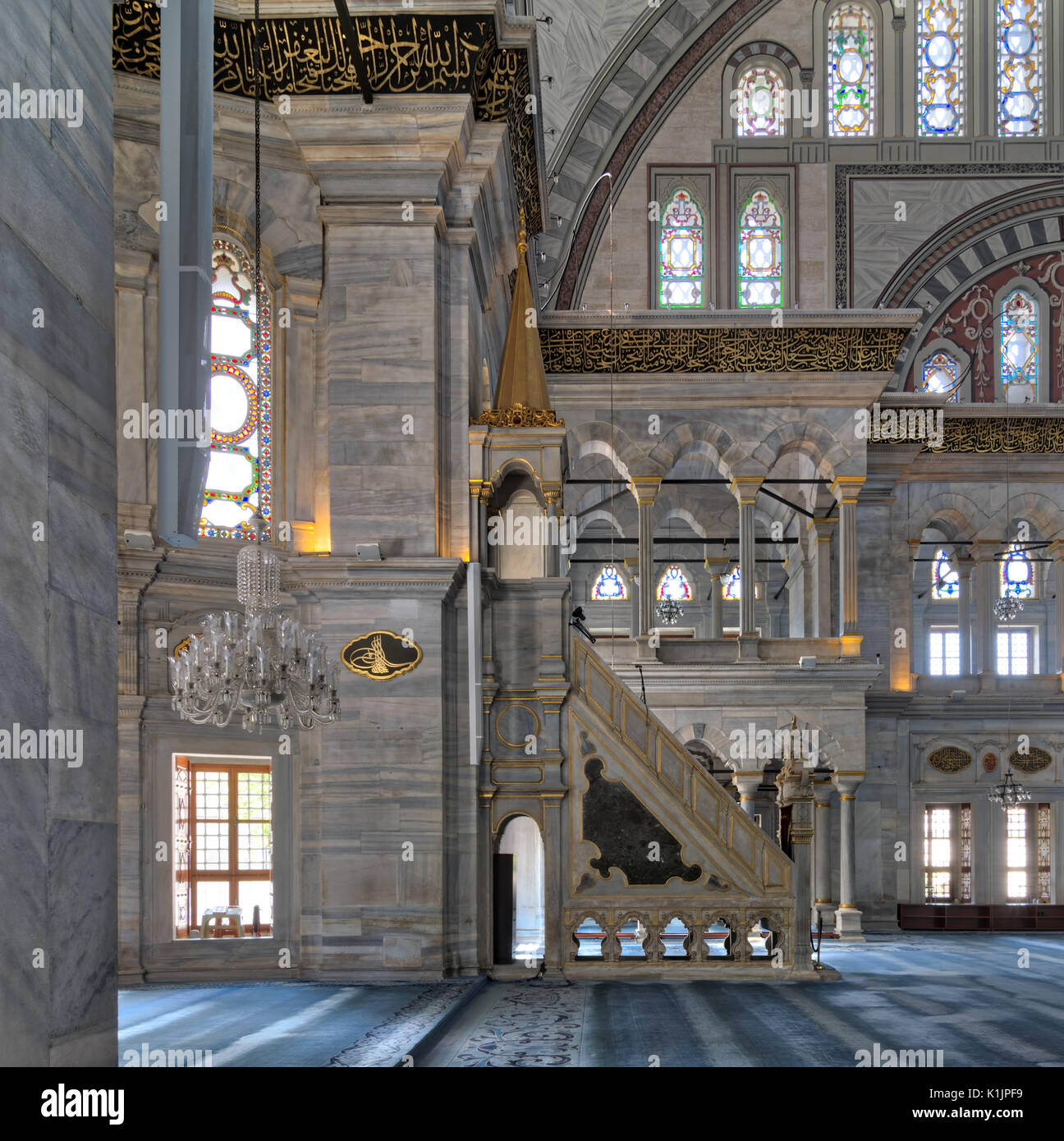 Interior shot of Nuruosmaniye Mosque, an Ottoman Baroque style mosque with minbar (platform), arches & colored stained glass windows located in Shembe Stock Photo