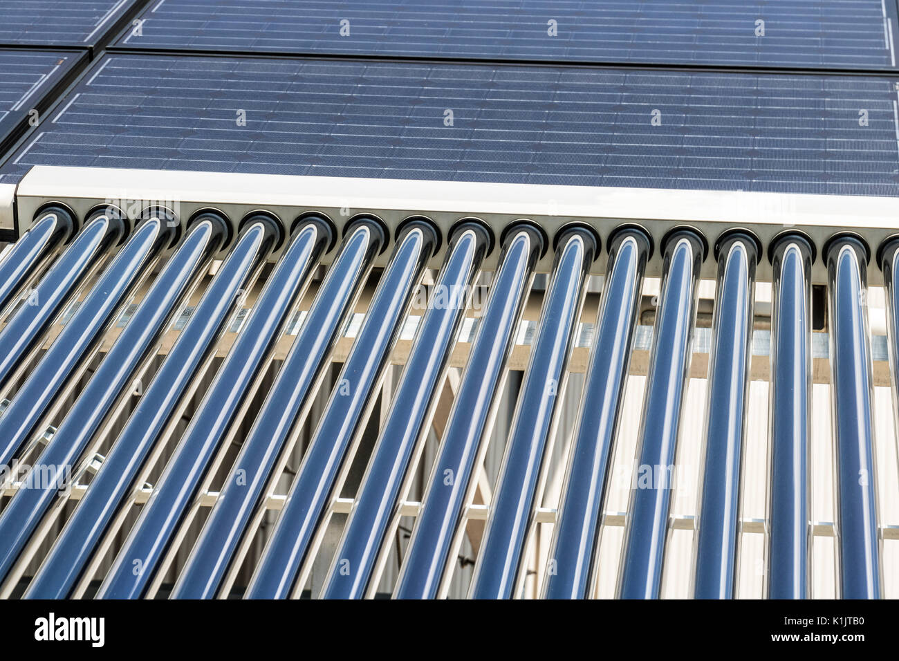 Solar Thermal Flat Panels with Evacuated Tube Collectors. Many companies are installing renewable energy sources to reduce their carbon footprint II Stock Photo