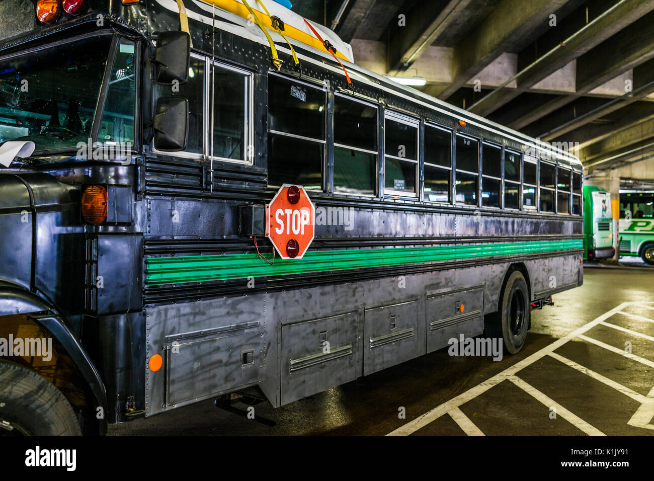 Washington DC, USA - July 1, 2017: Inside Union Station parking garage with black painted converted school bus Stock Photo