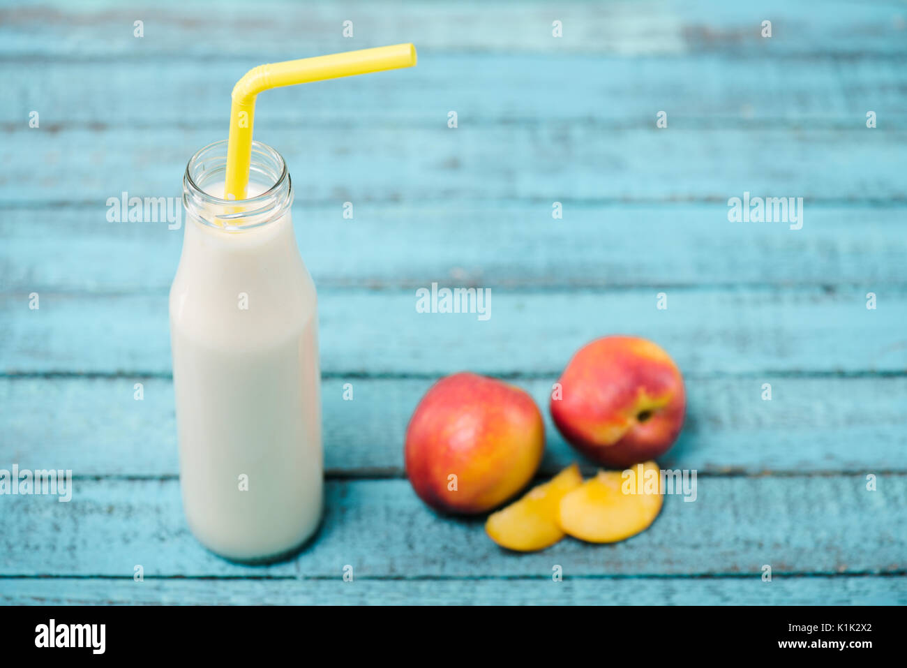 Close-up view of delicious fruity milkshake in glass bottle with drinking straw Stock Photo