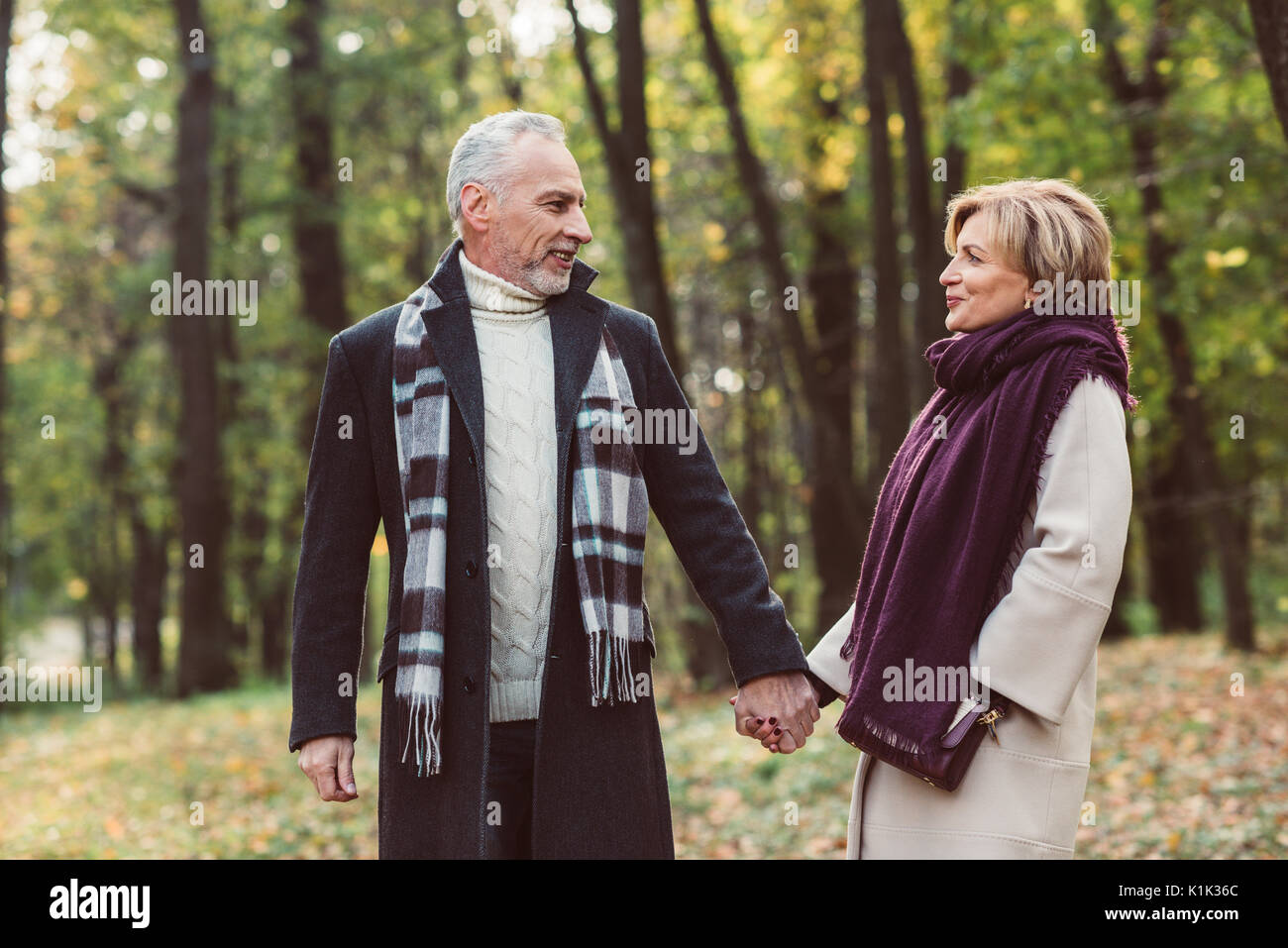 Middle Aged Couple Walking Holding Hands High Resolution Stock ...