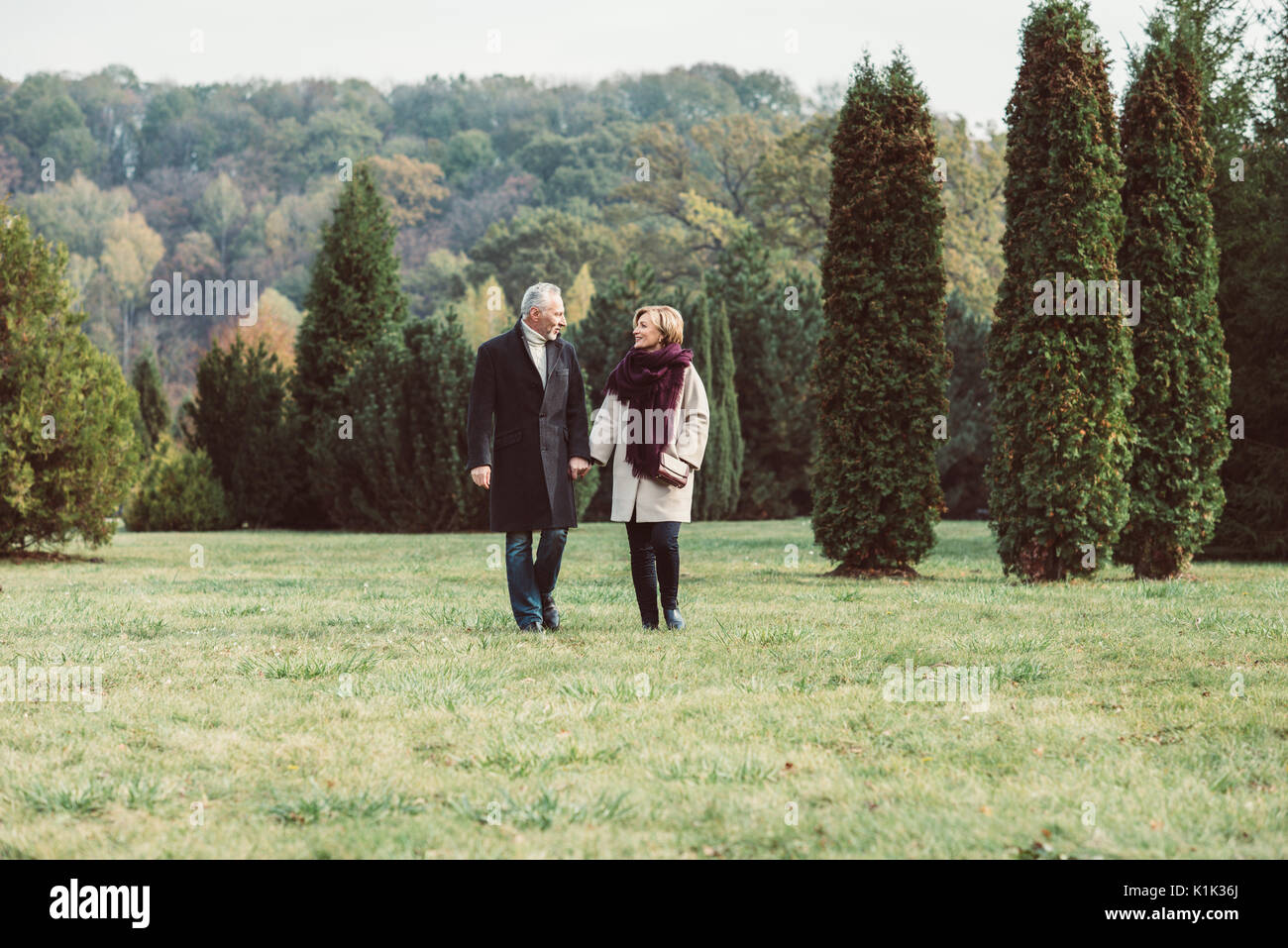 Middle aged couple holding hands walk hi-res stock photography and ...