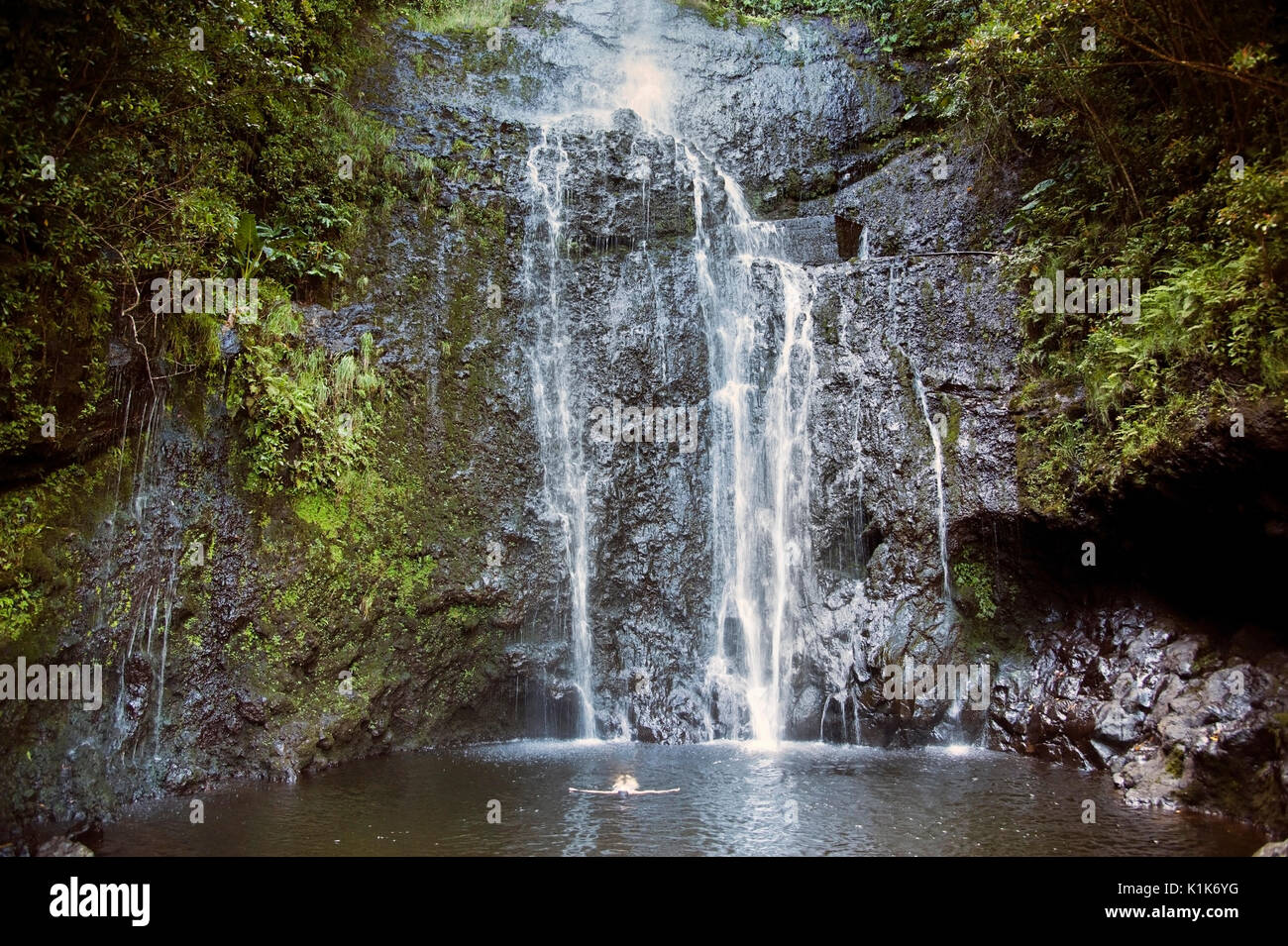 Waterfalls cascade down mountainous terrain in the rain forest of Maui in the Hawiian Islands. Stock Photo