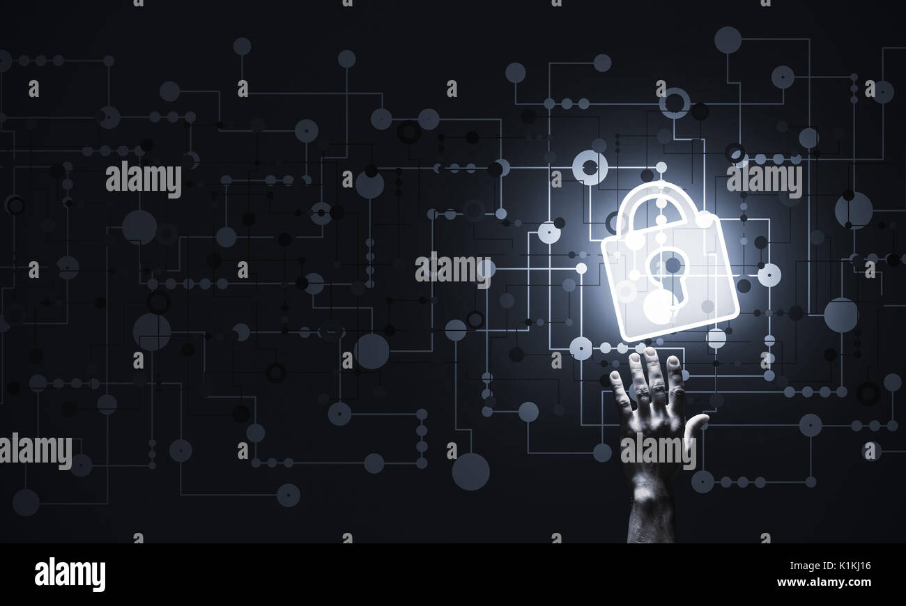 Lock glowing icon pressed with finger on dark background Stock Photo