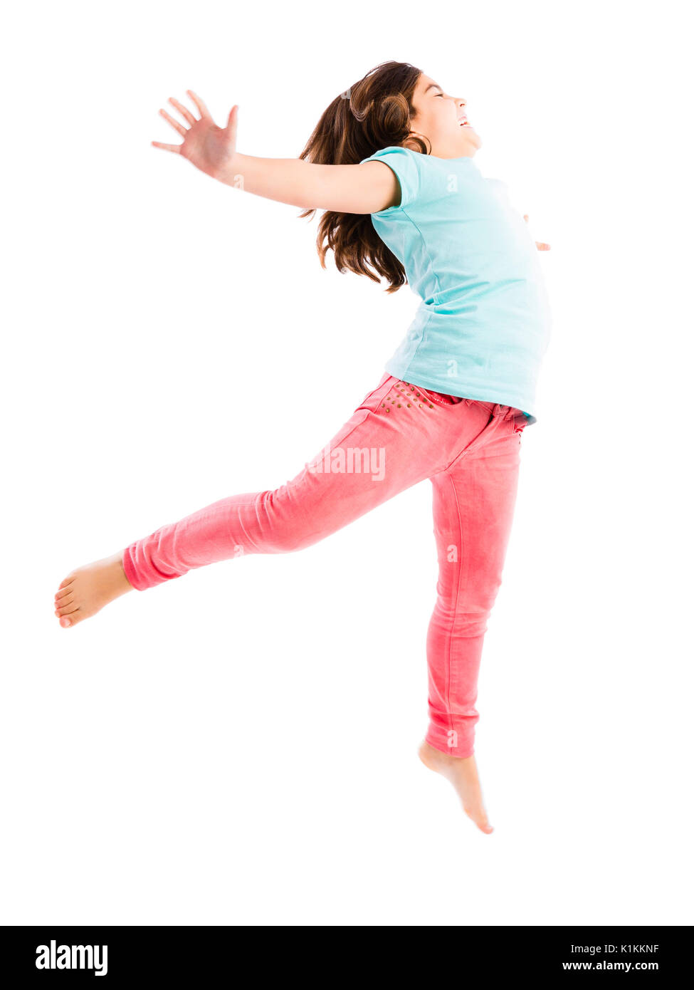 Beautiful and happy young girl jumping Stock Photo