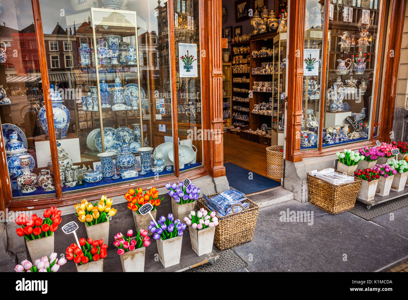 Netherlands, South Holland, Delft, blue Delftware pottery and tulips at a souvenir shop Stock Photo