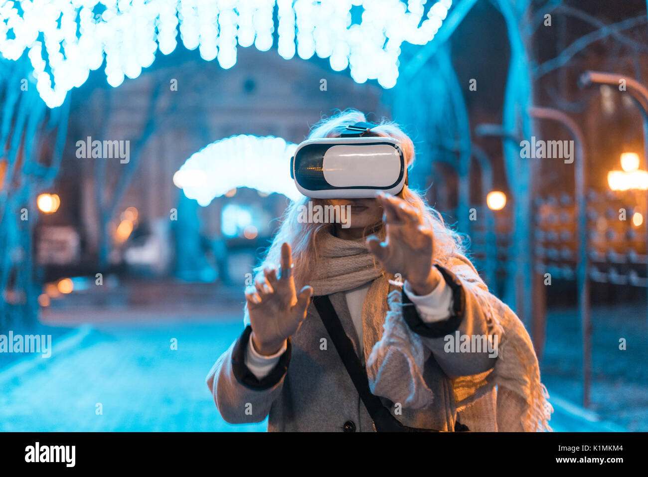 Young girl getting experience VR headset, is using augmented reality ...