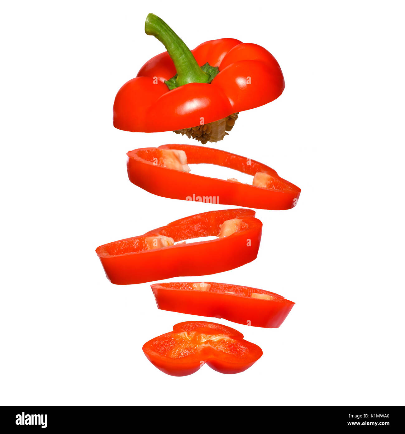 Creative concept with flying red paprika. Sliced floating pepper isolated. Levity vegetable. Capsicum Stock Photo