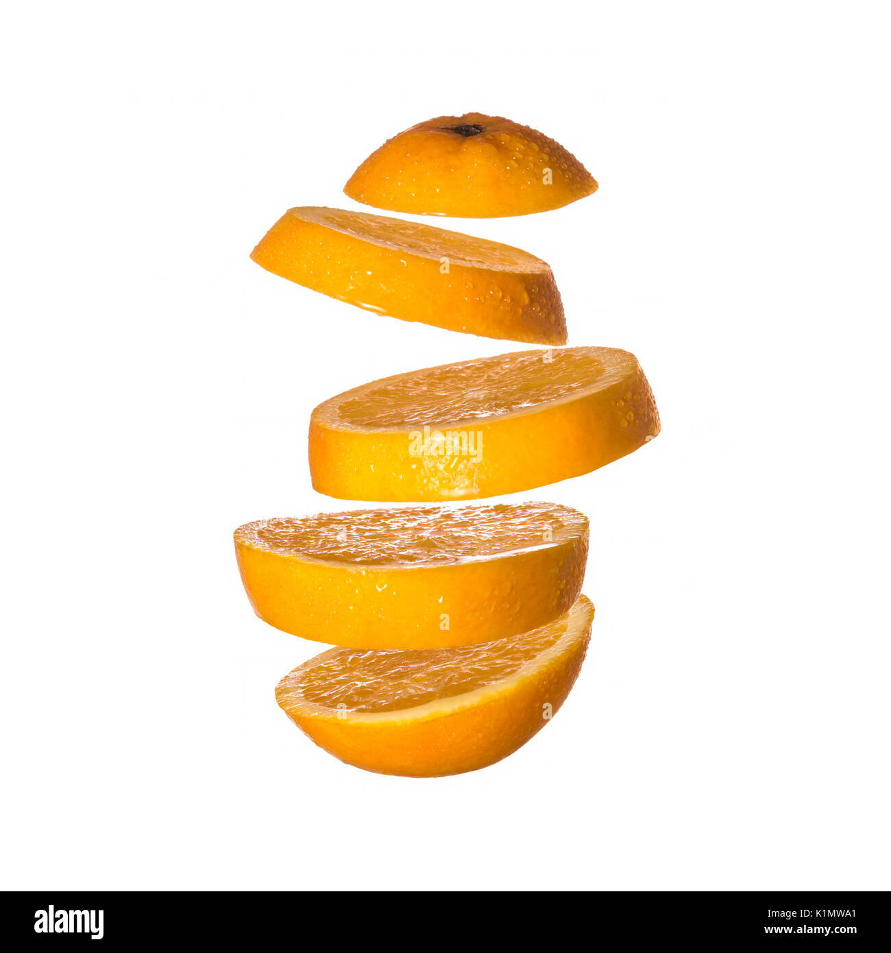 Creative concept with flying orange. Sliced orange isolated on white background. Levity fruit floating in the air. Stock Photo