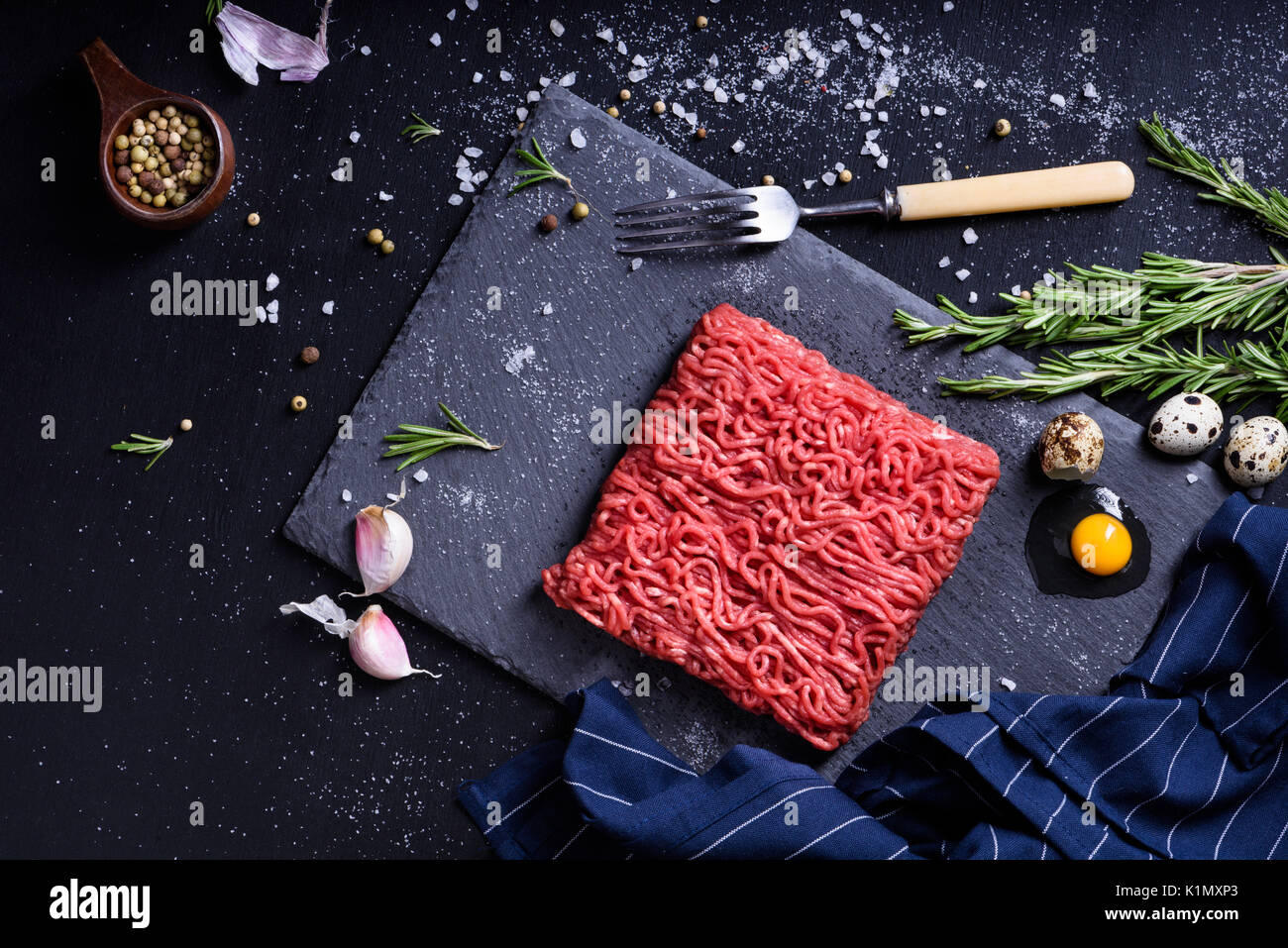 Fresh raw meat with spices. Ground beef steak on a dark table. Top view Stock Photo Alamy