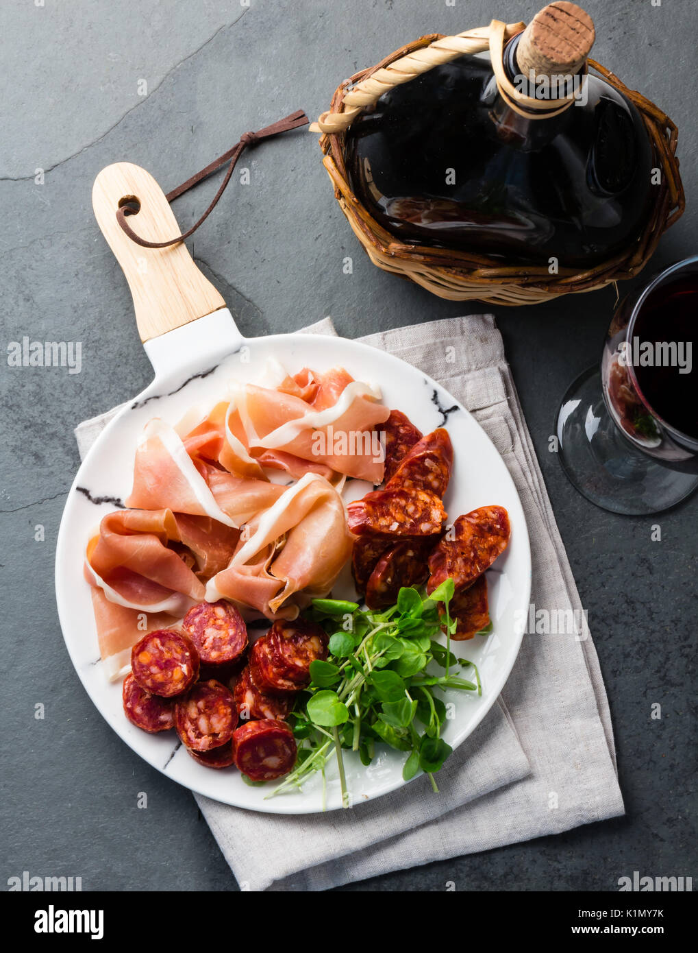 Iberian food. Spanish ham jamon serrano and salami on white marbled