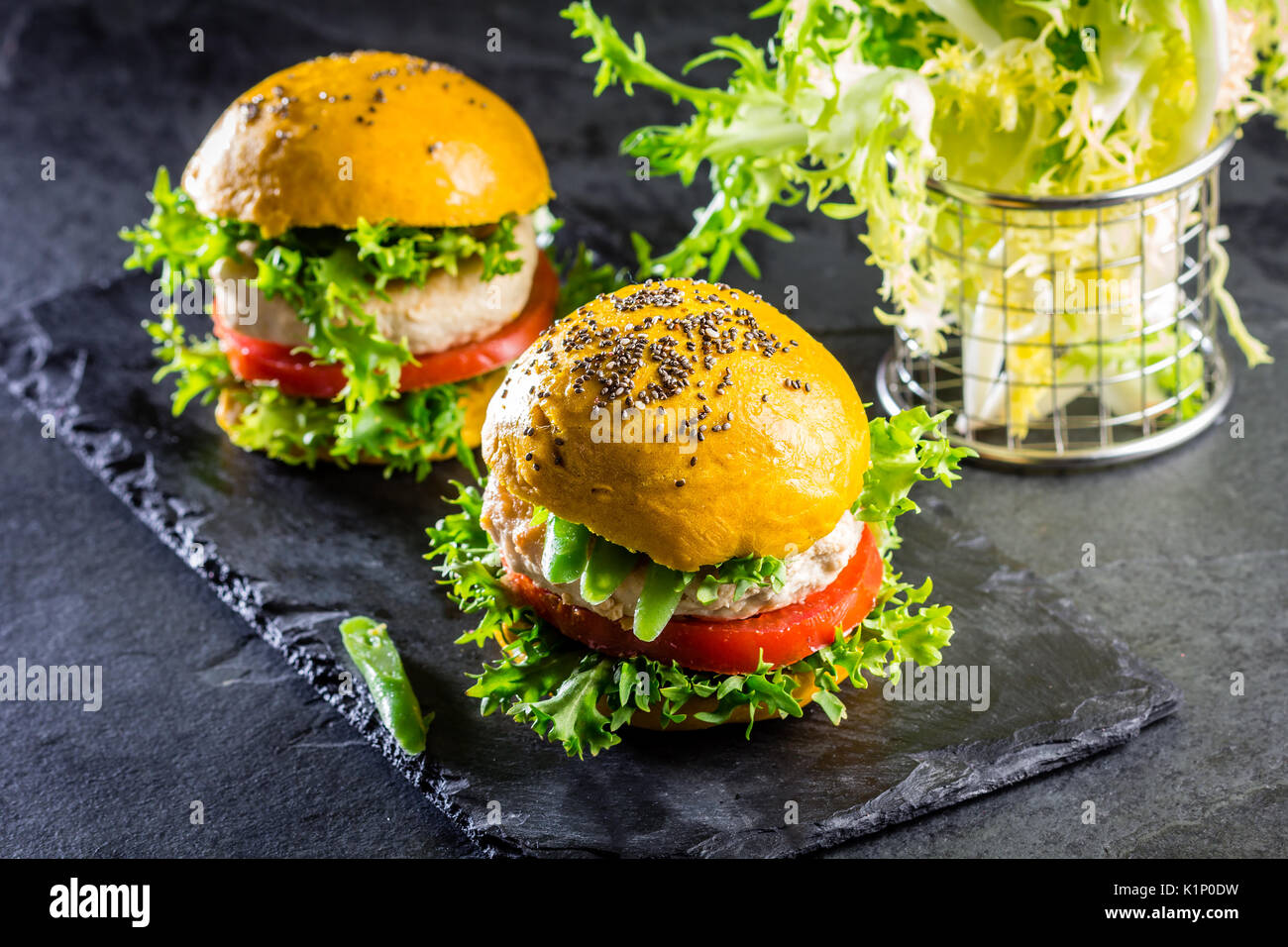 Colored yellow burgers. Homemade American chicken burgers hamburgers
