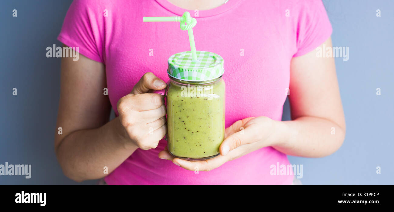 Healthy green smoothie with asparagus in woman's hand. Vegan, raw food