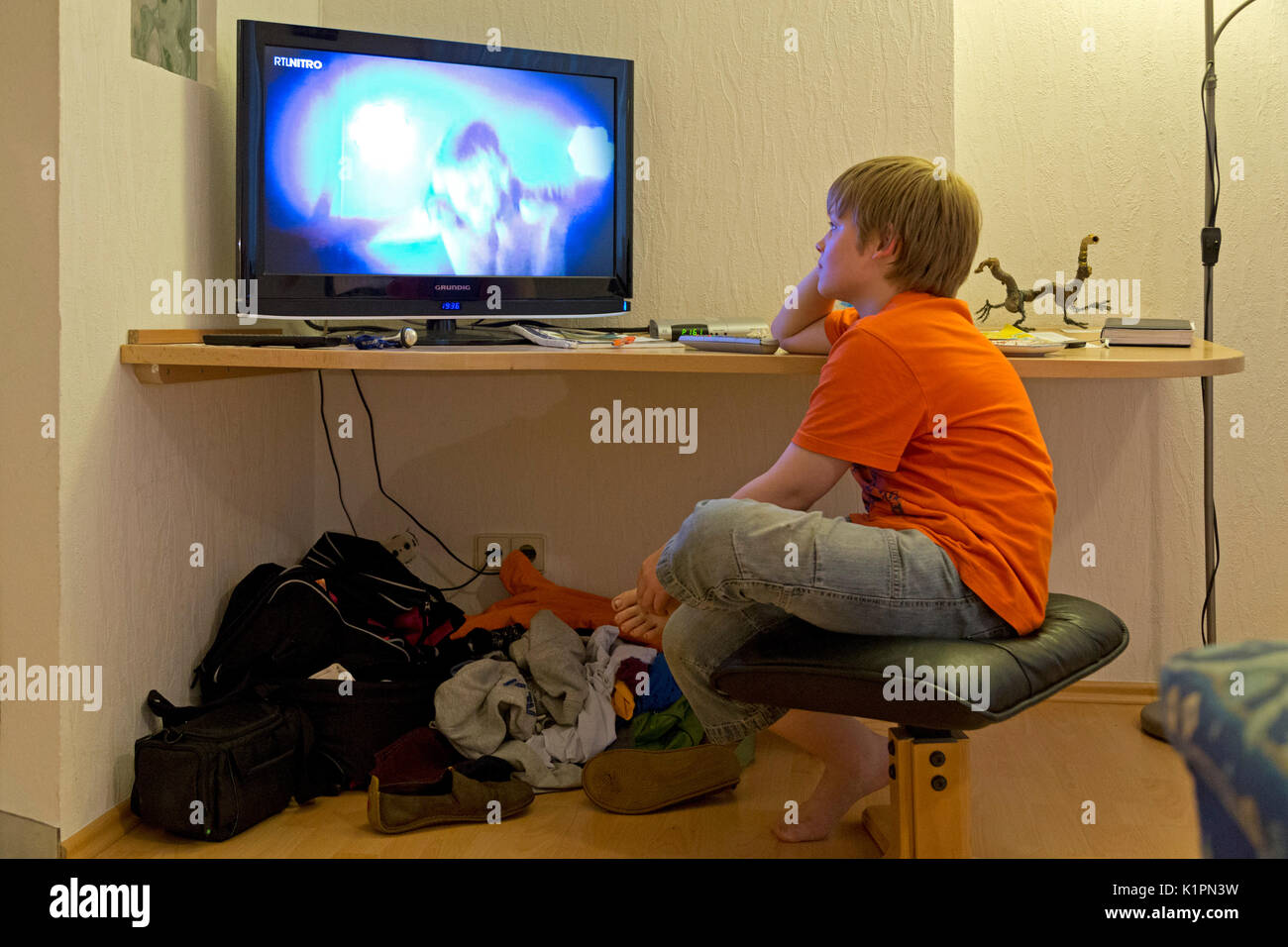 young boy watching TV Stock Photo