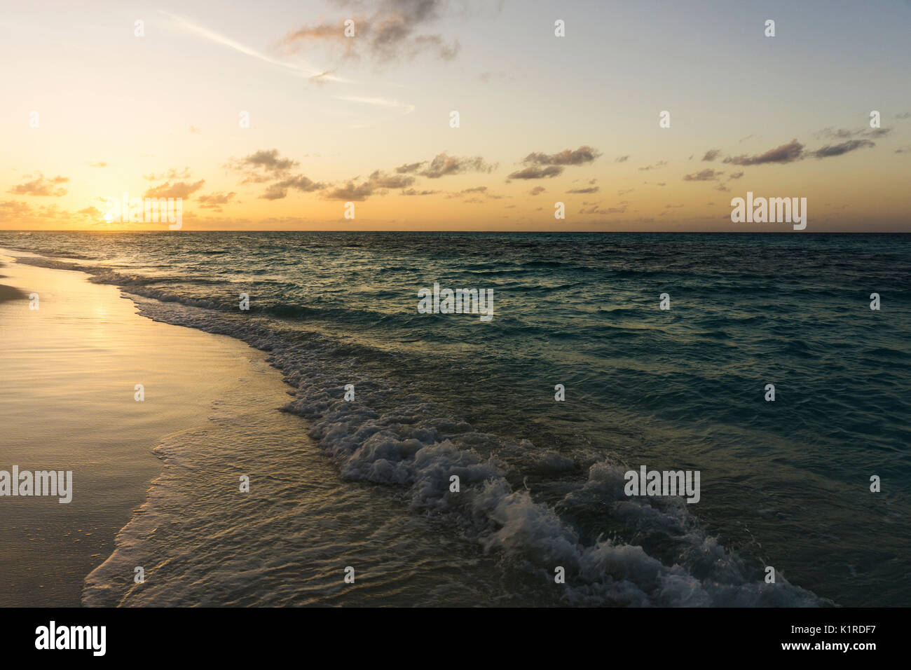 Dramatic sunset over tropical beach and sea Stock Photo - Alamy