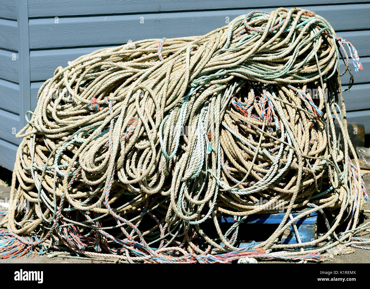 A pile of fishing rope on the quayside. Stock Photo