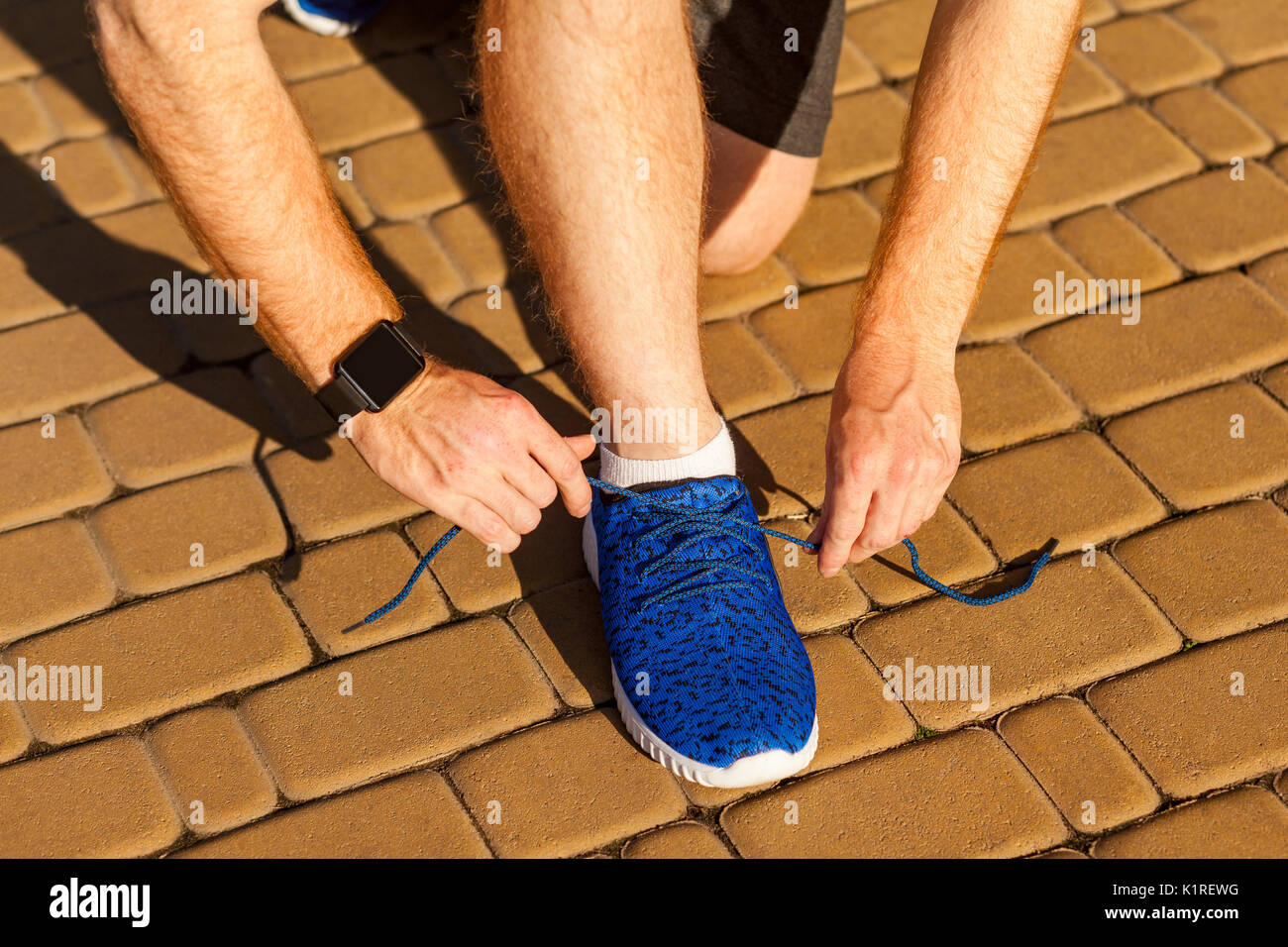 Tie shoelaces. Blue sneakers. Sport Stock Photo