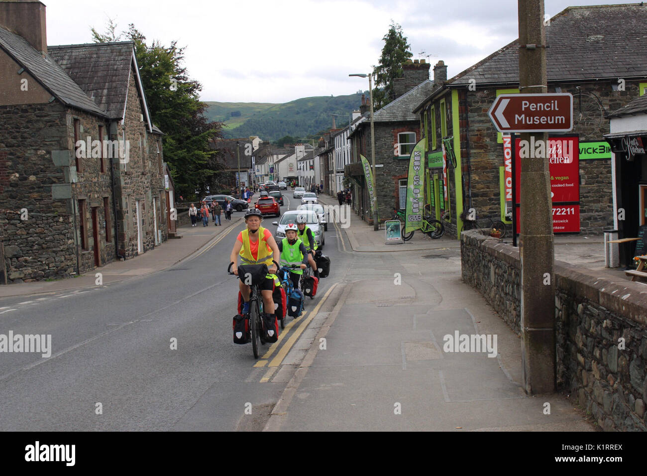 Keswick Cumbria, United Kingdom. 27th Aug, 2017. What looks like a family group cycle past the Pencil Museum this afternoon in Keswick Credit: David Billinge/Alamy Live News Stock Photo