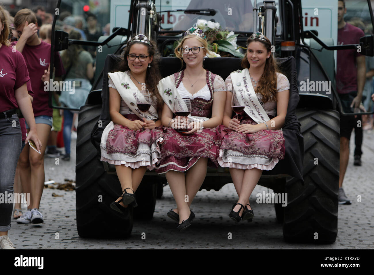 Worms, Germany. 27th August 2017. The Traubenbluten princesses from Westhofen sit on the front of a tractor. The first highlight of the 2017 Backfischfest was the big parade through the city of Worms with over 80 groups and floats. Community groups, music groups and business from Worms and further afield took part. Credit: Michael Debets/Alamy Live News Stock Photo