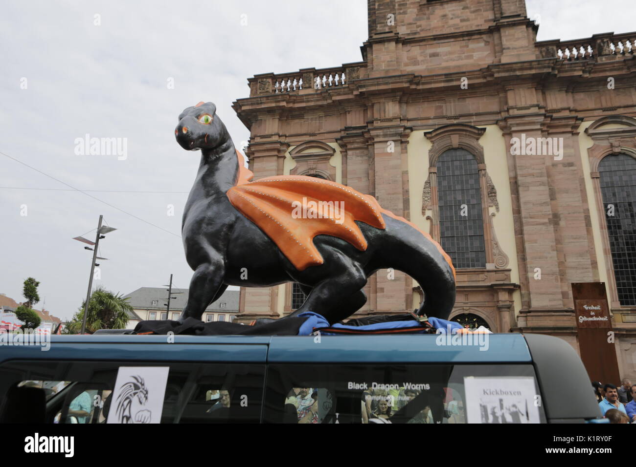 Worms, Germany. 27th August 2017. A large papier-mache dragon, the symbol of Worms, stands on top of a van. The first highlight of the 2017 Backfischfest was the big parade through the city of Worms with over 80 groups and floats. Community groups, music groups and business from Worms and further afield took part. Credit: Michael Debets/Alamy Live News Stock Photo