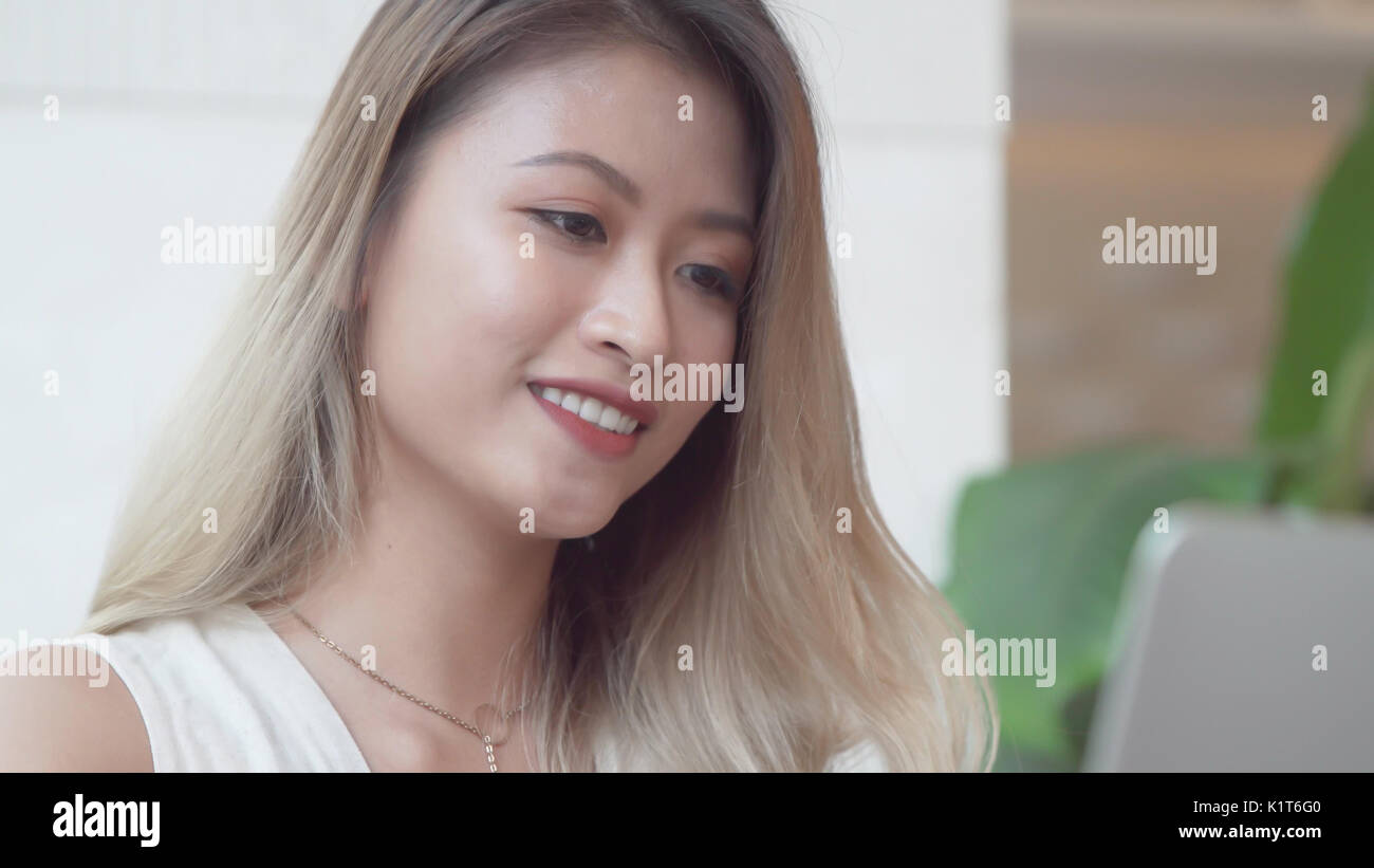 Happy asian student working with laptop computer Stock Photo - Alamy