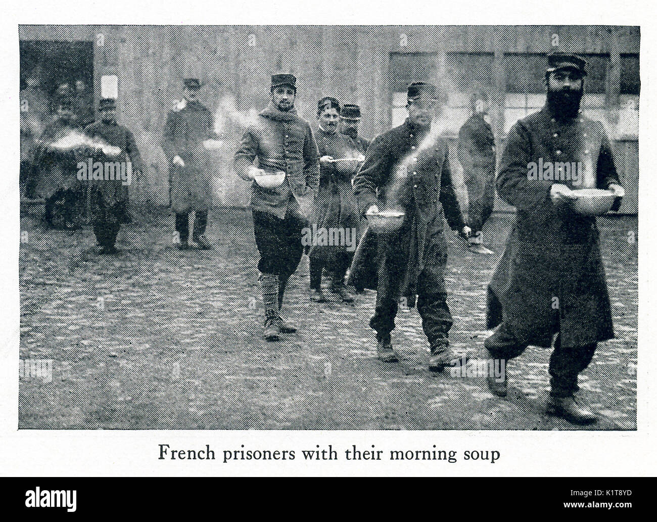This photo taken in early World War I has the caption: French prisoners with their morning soup. Stock Photo