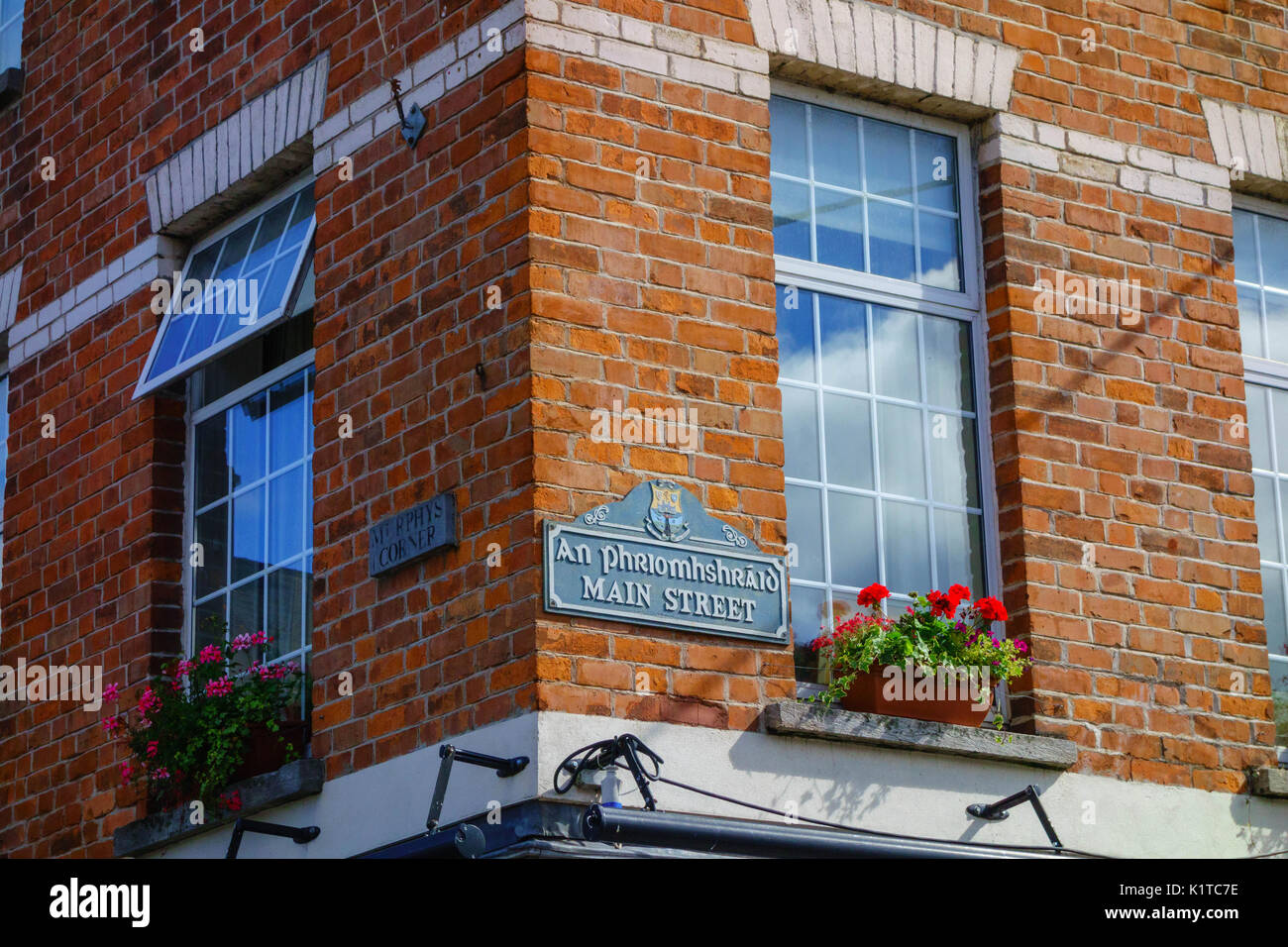 Red brick wall showing street names as Main Street and Murphys Corner