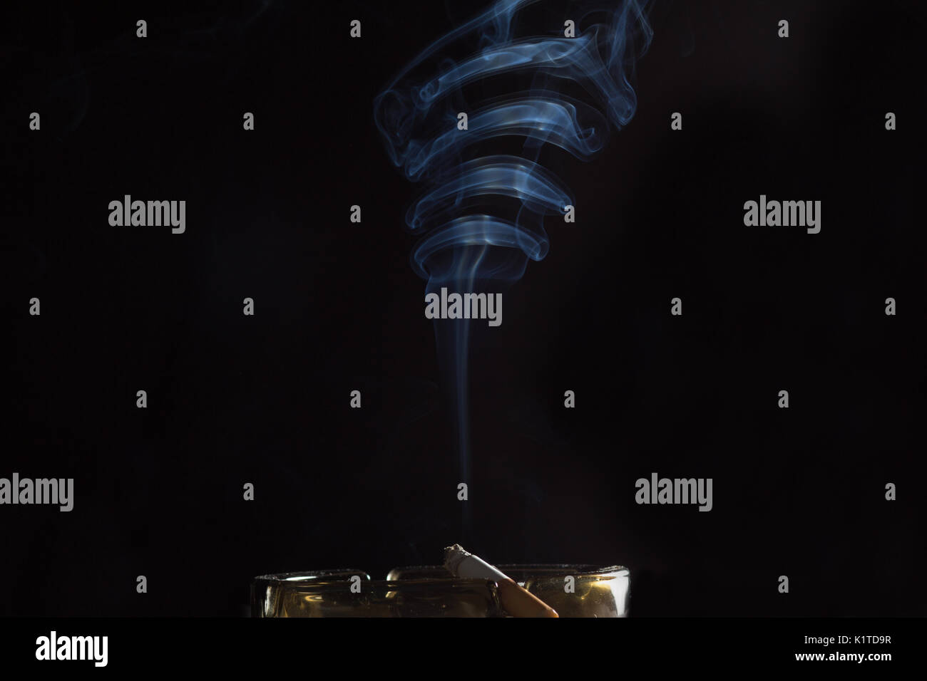 smoke from a cigarette on an ashtray Stock Photo