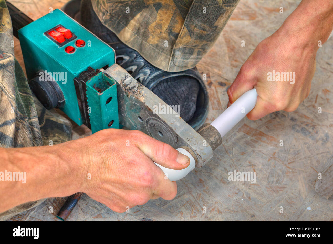 Plumber installing pipes in home, ppr plastic pipe hot melt welding
