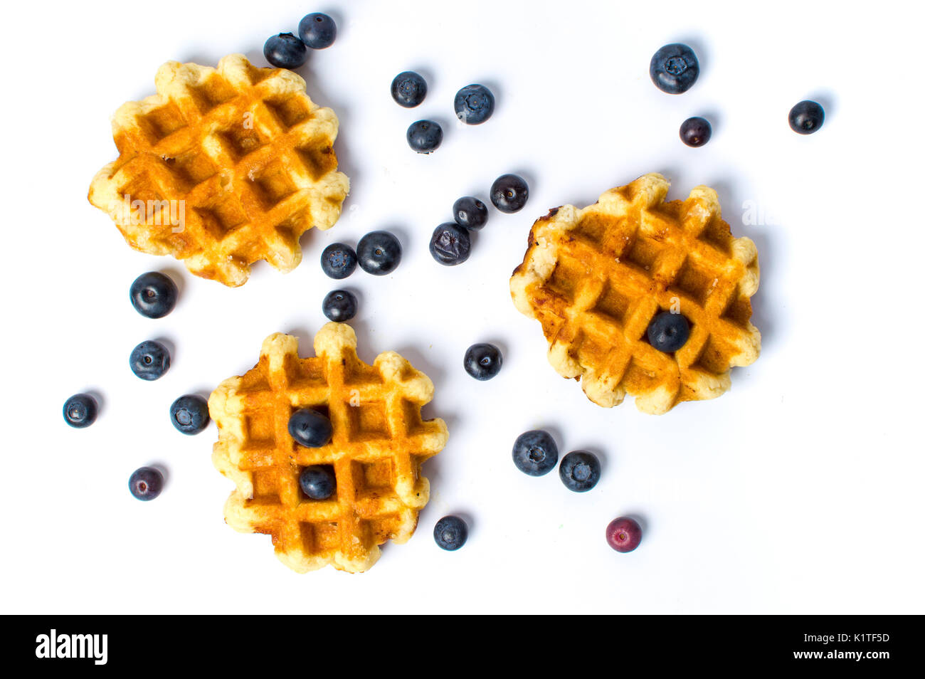 Baked waffles and blueberriesi solated on white background Stock Photo