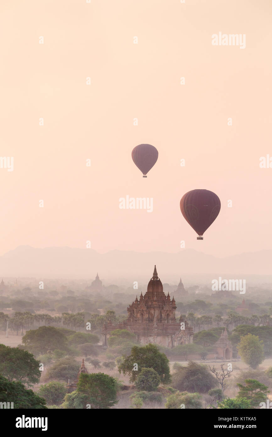 Hot air balloons floating over Bagan temples at sunrise, Bagan, Myanmar Stock Photo