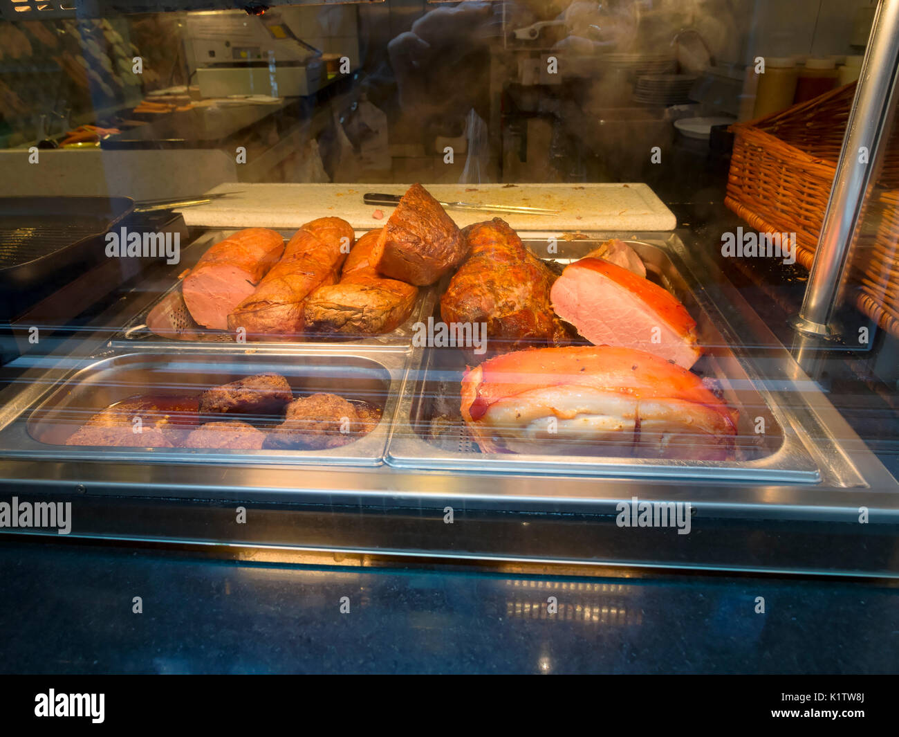 Roast meats on display in a cafe window in Cochem, Germany Stock Photo