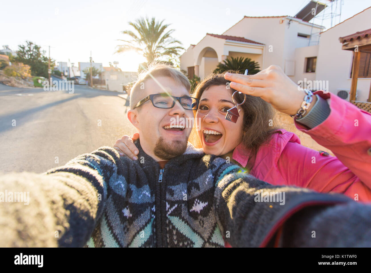 happy young laughing cheerful couple man and woman handing their new ...