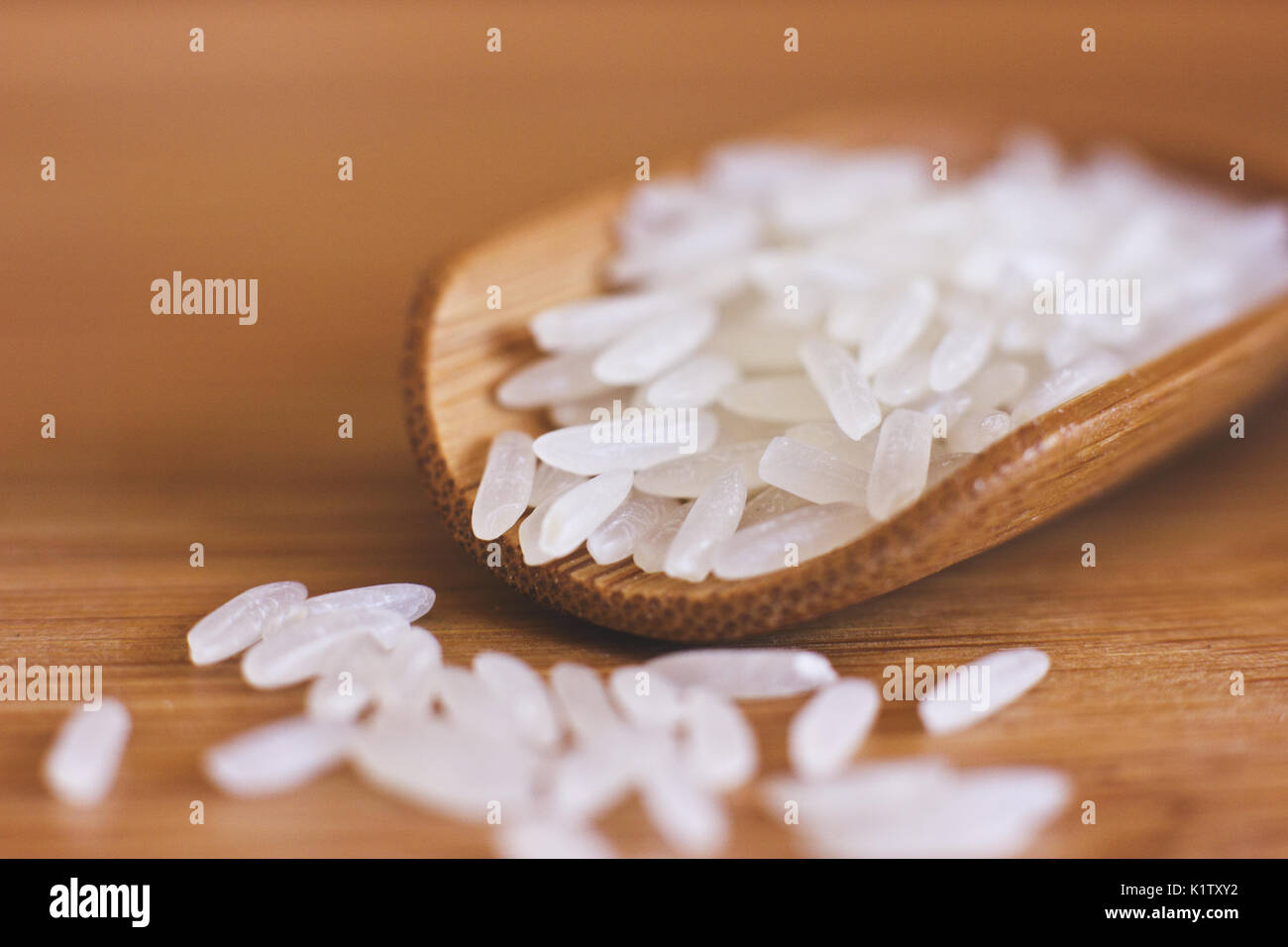 White rice in the wooden spoon. Macro Stock Photo