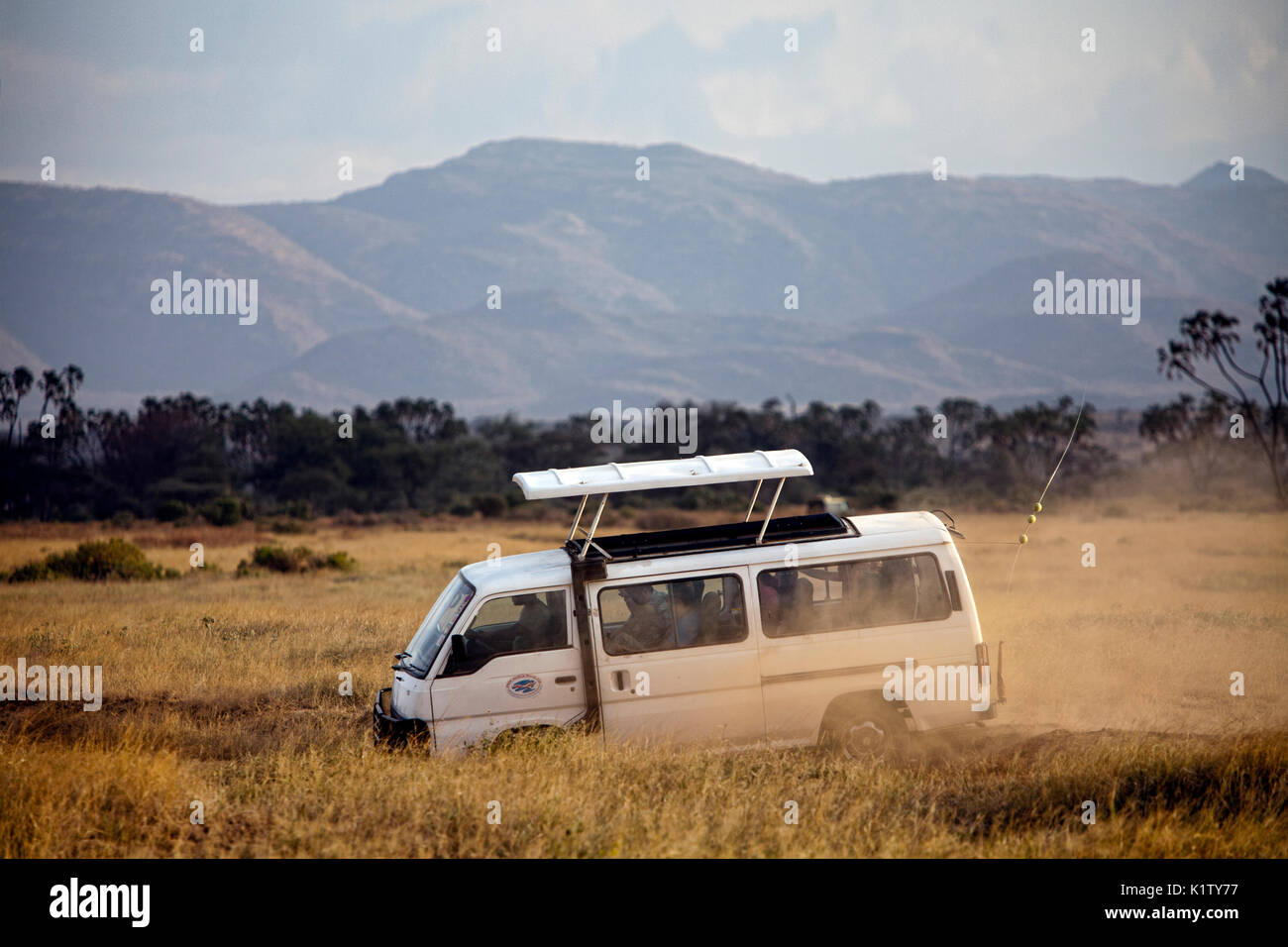 Safari rig filled with tourists driving fast in search of game in the Samburu National Reserve, Kenya, Africa. Stock Photo