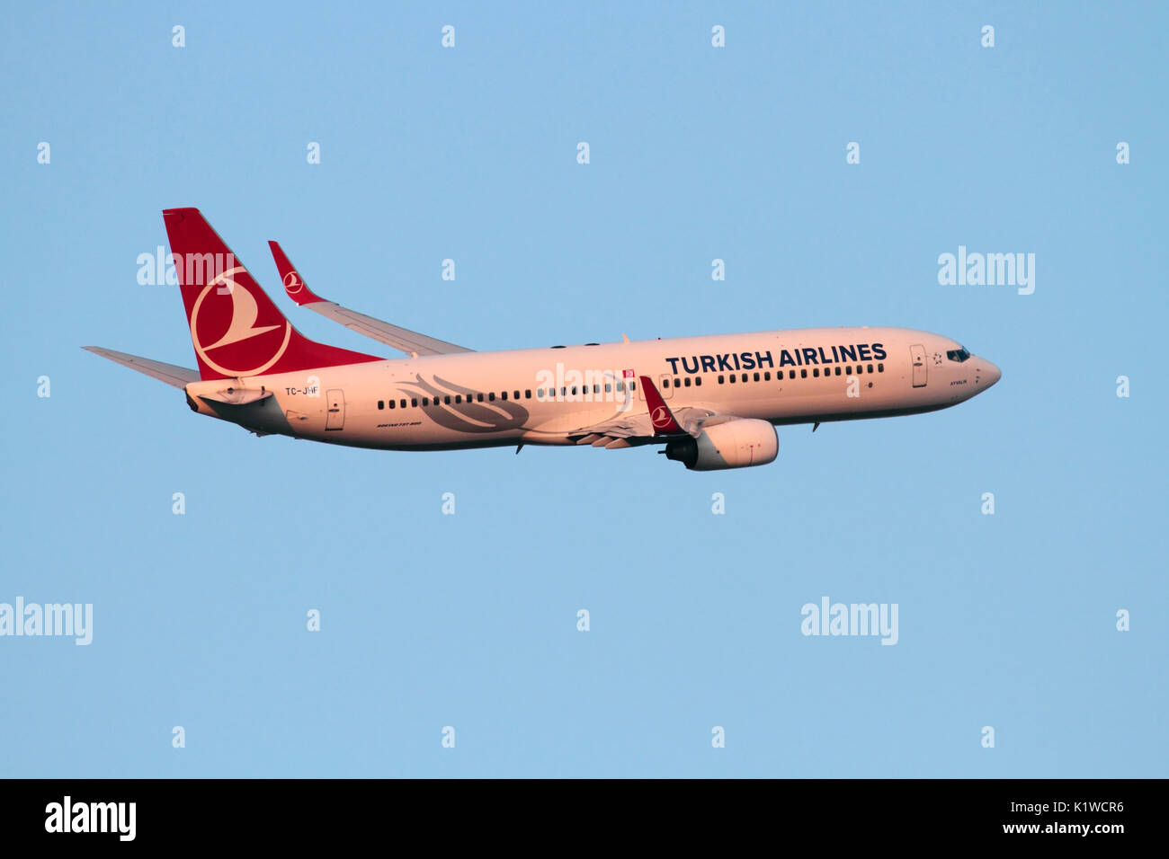 Boeing 737-800 passenger jet plane belonging to Turkish Airlines in flight on departure at sunset. Air travel and commercial flying. Stock Photo