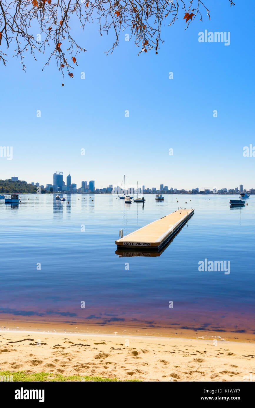 Tree framed view of a swimming jetty in Matilda Bay on the Swan River at Crawley, Perth, Western Australia Stock Photo