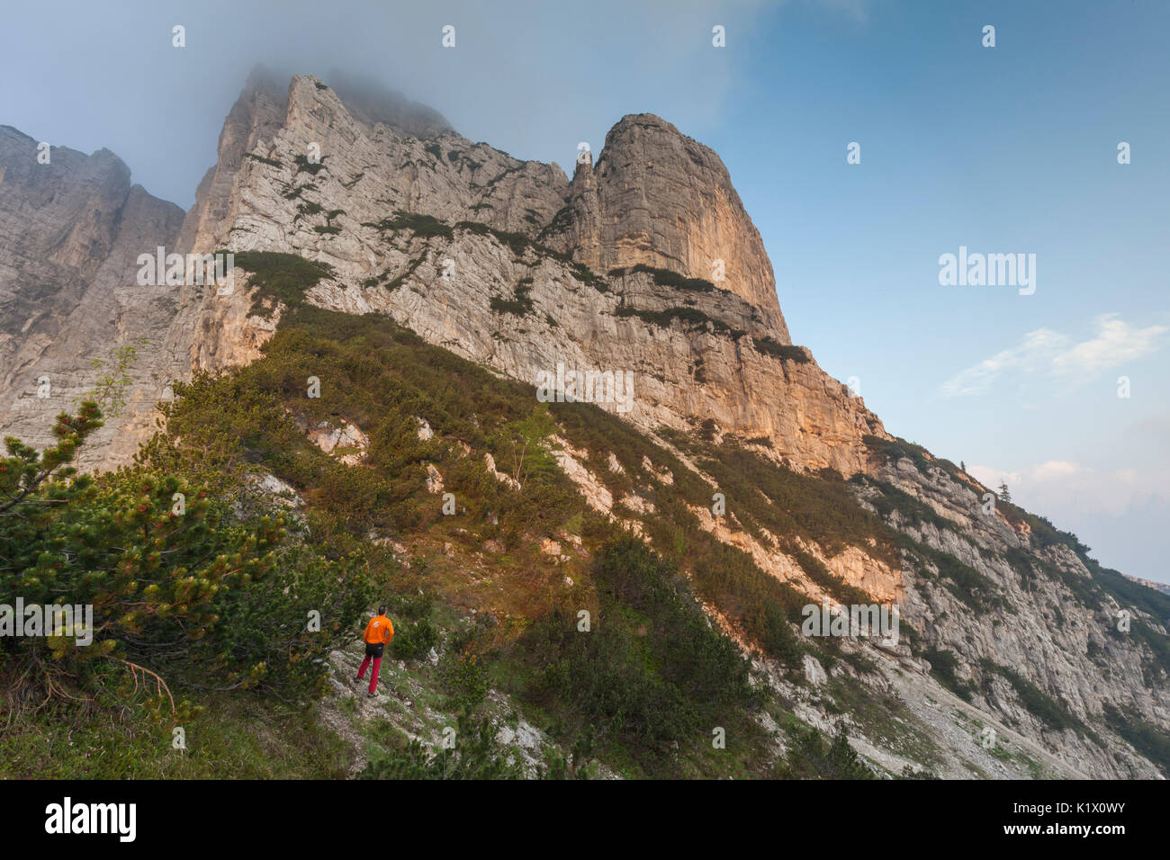Europe, North Italy, Veneto, Belluno, Monti del Sole, Dolomites. Man looking at the first light on the north face of Piz de Mezodi. Stock Photo
