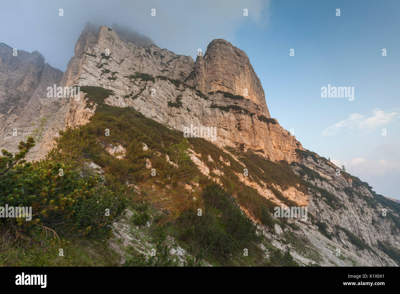Europe, North Italy, Veneto, Belluno, Monti del Sole, Dolomites. Man looking at the first light on the north face of Piz de Mezodi. Stock Photo