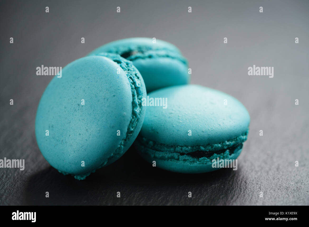 bright azure macarons on slate background, shallow focus Stock Photo