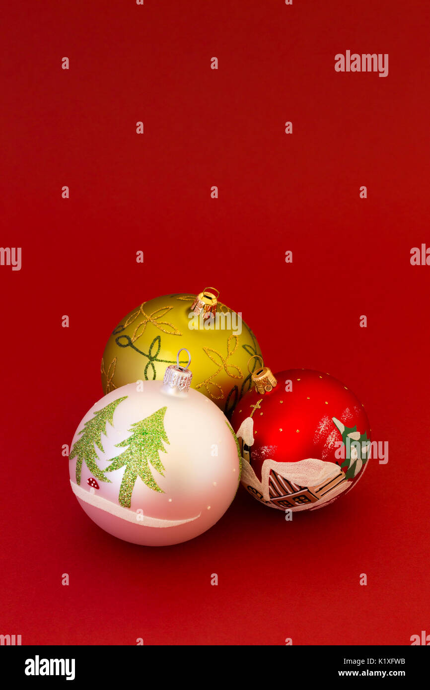 Beautiful white, red and green christmas balls on dark red background. Stock Photo