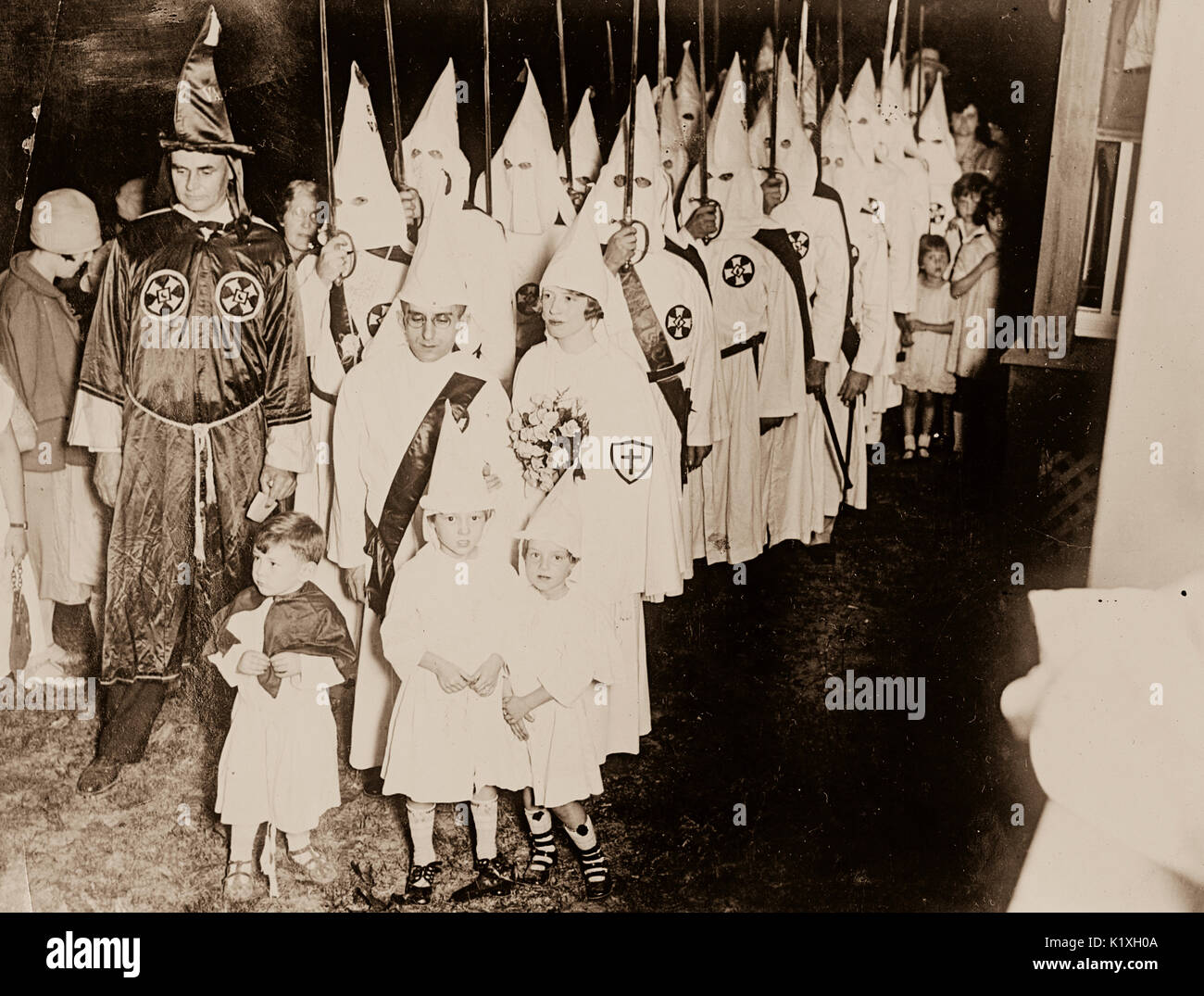 Ku Klux Klan members - men, women and children in robes and hoods. Stock Photo