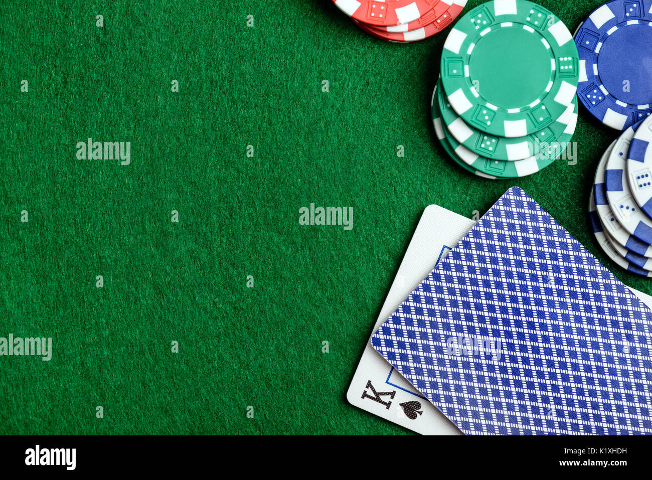 Casino green table with chips and play cards. Poker game concept Stock Photo