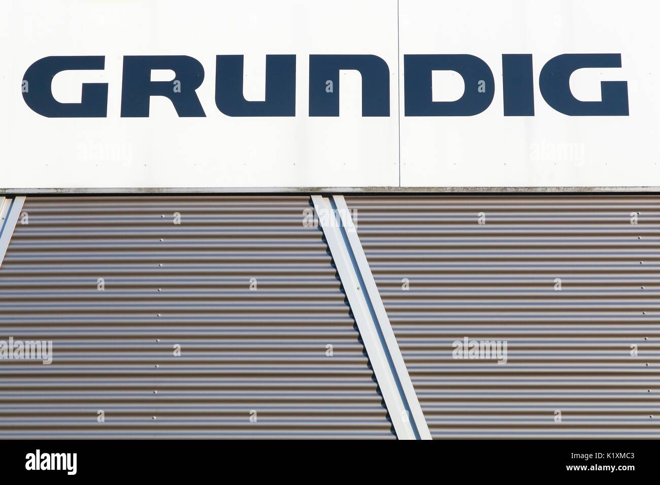 Dortmund, Germany - July 21, 2017: Grundig logo on a wall. Grundig is a German manufacturer of consumer electronics and domestic appliances Stock Photo