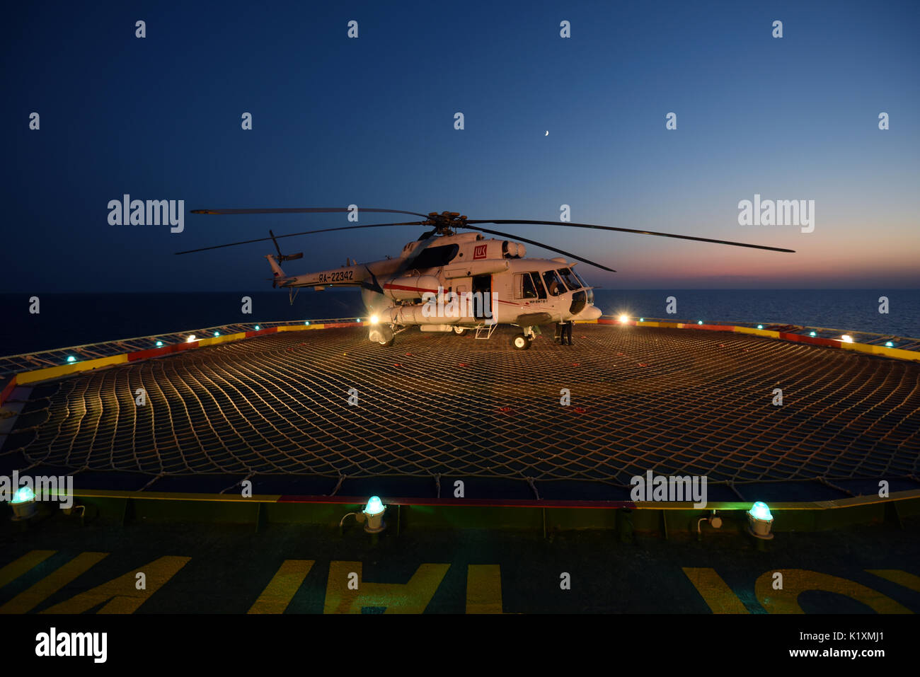 Helicopter on oil platform on Korchagina Lukoil oil field at the north of Caspian sea, Astrakhan Region, Russia Stock Photo