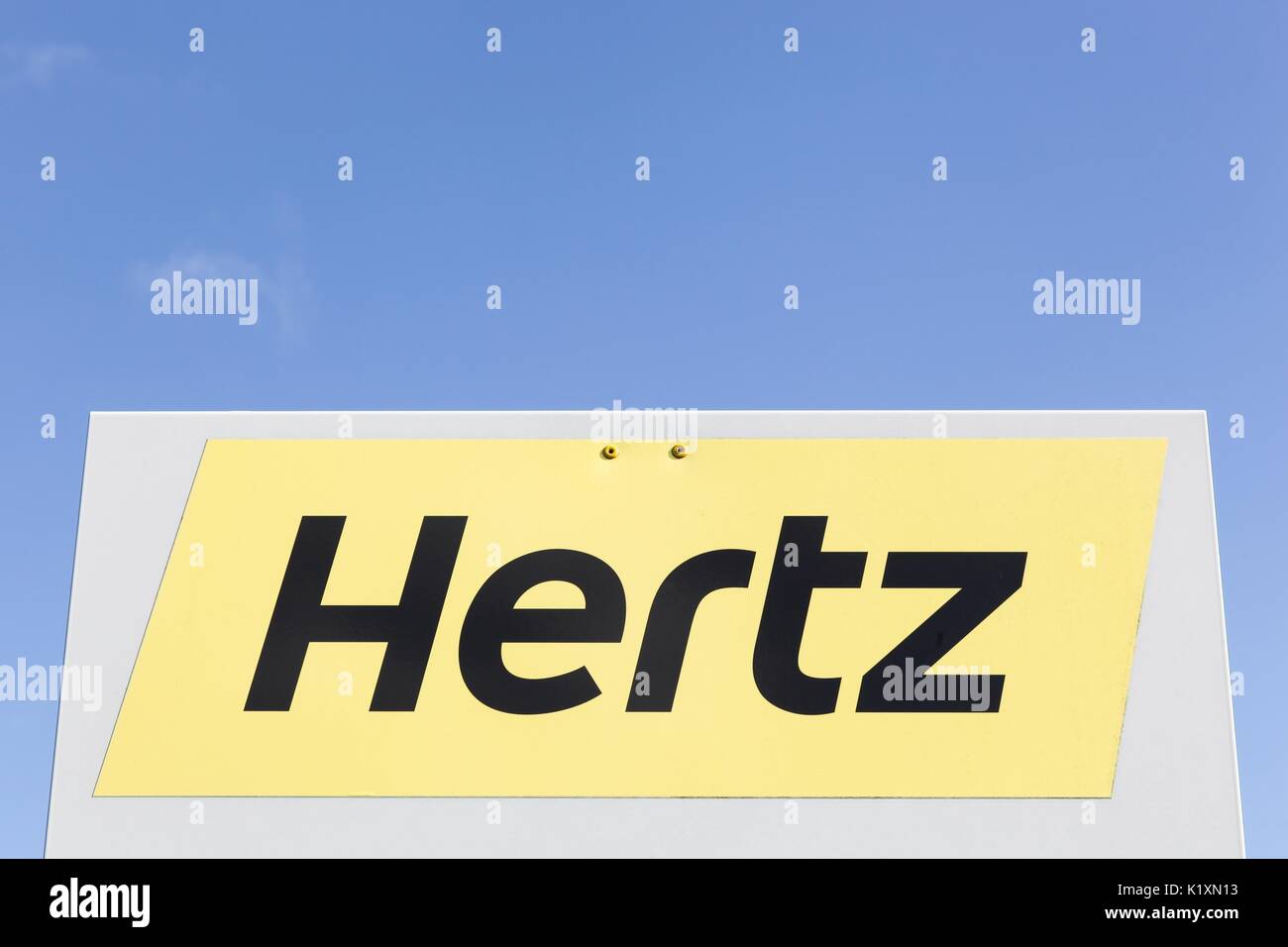 Billund, Denmark - August 1, 2017: Hertz logo on a panel. Hertz is an American car rental company with international locations in 145 countries worldw Stock Photo